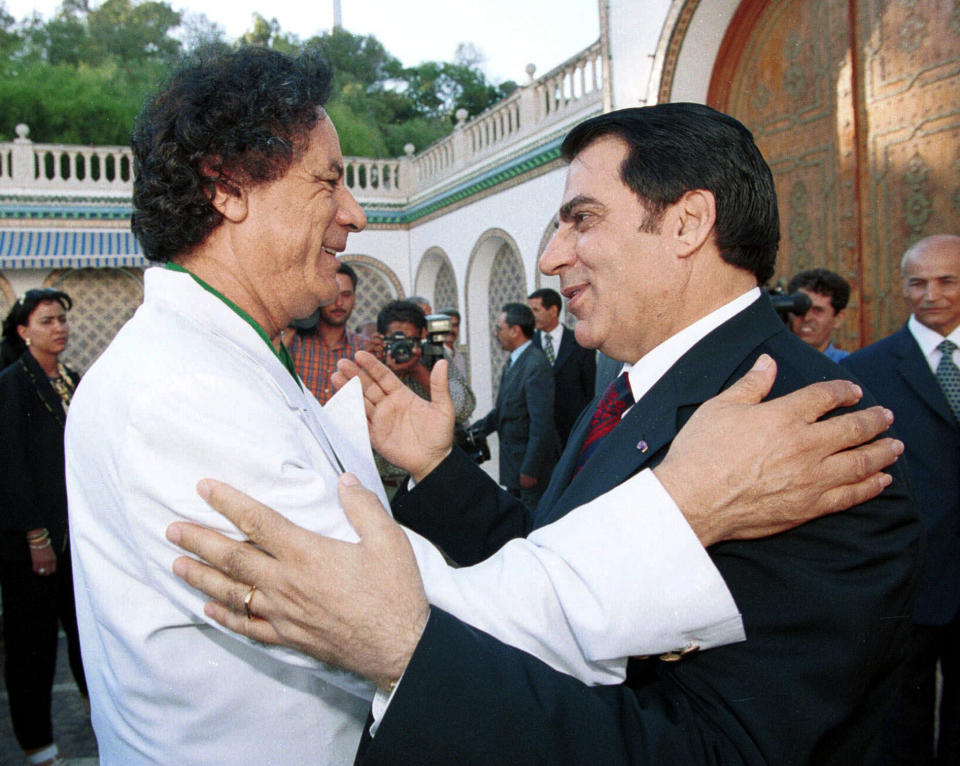 FILE - In this Aug.2, 2000 file photo, Libyan leader Col. Moammar Gadhafi, left, is welcomed by Tunisian President Zine El Abidine Ben Ali in Tunis. Tunisia's autocratic ruler Zine El Abidine Ben Ali, toppled in 2011, died in exile in Saudi Arabia. (AP Photo, File)