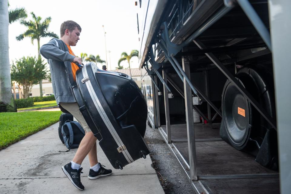 Florida Atlantic band member Dylan Brogdon loads a sousaphone onto the bus Wednesday before departure at Baldwin Arena in Boca Raton. The basketball team will play San Diego State in the NCAA Tournament semifinal on Saturday, and the band will be there, too.