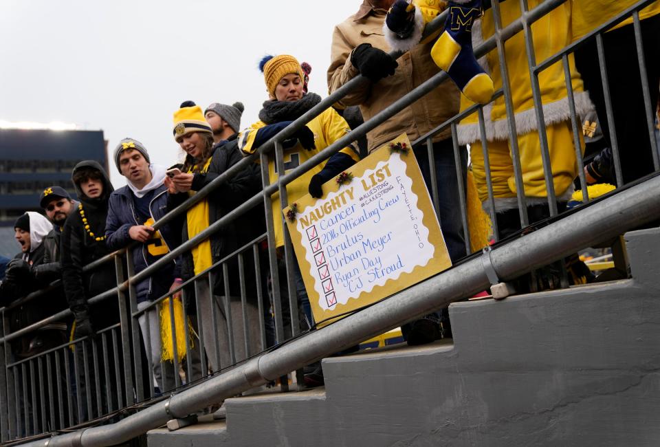 Michigan Wolverines fans yell as players and spectators enter the tunnel onto the field prior to the NCAA football game against the Ohio State Buckeyes at Michigan Stadium in Ann Arbor on Saturday, Nov. 27, 2021.