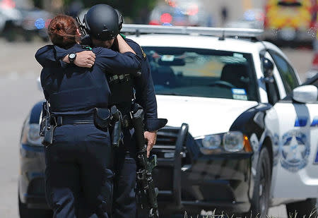 Dallas police officers embrace after police responded to a shooting incident in Dallas, Texas, U.S. May 1, 2017. REUTERS/Brandon Wade
