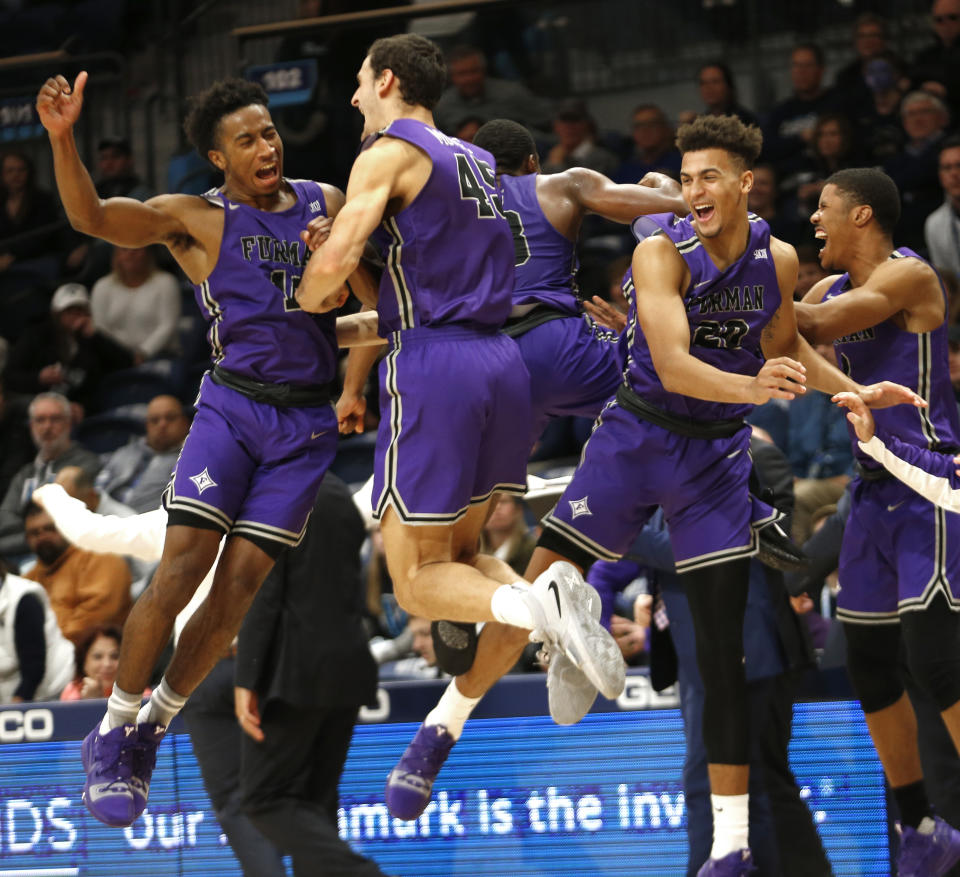 Furman guard Alex Hunter (10) and forward Clay Mounce (45) celebrate after their team defeated Villanova 76-68 in overtime in an NCAA college basketball game, Saturday, Nov. 17, 2018, in Villanova, Pa. (AP Photo/Laurence Kesterson)