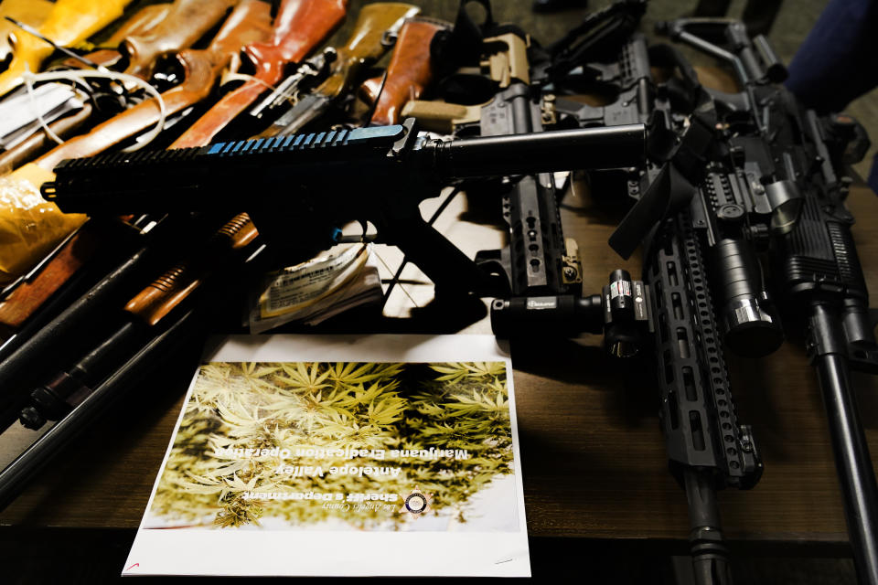 Part of a cache of confiscated firearms are shown by Los Angeles County Sherrif's Office at a news conference downtown Los Angeles Wednesday, July 7, 2021. Authorities seized tens of millions of dollars worth of illegal marijuana grown in the high desert Tuesday as part of an effort to curtail the black market's grip on Southern California. Twenty-three people were arrested in the crackdown Tuesday in the Antelope Valley, 70 miles (112.65 kilometers) north of Los Angeles, and officials planned to bulldoze 500 illegal grows in the area over the coming days. (AP Photo/Damian Dovarganes)