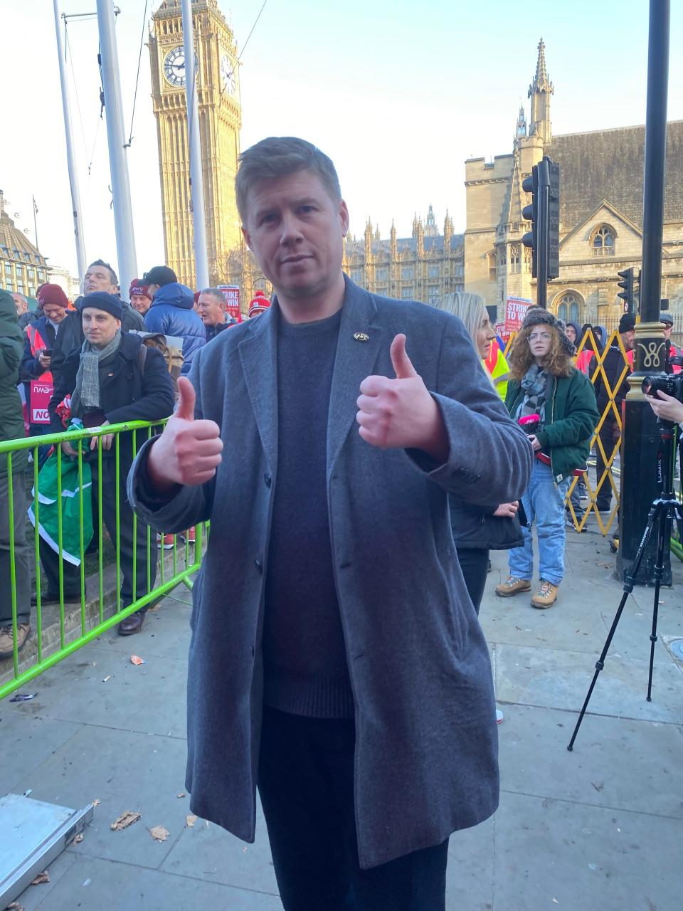 Eddie Dempsey shows support for striking postal workers at the Parliament Square rally. (Mustafa Qadri/The Independent)