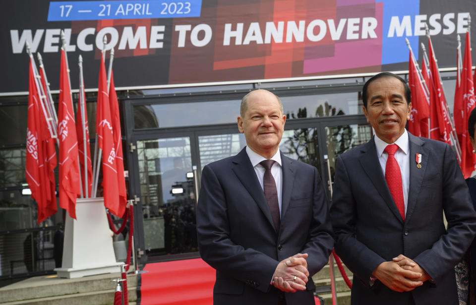 German Chancellor Olaf Scholz, left, and Joko Widodo, right, President of Indonesia, stand at the opening of the Hanover Messe industrial trade fair at the HCC Hanover Congress Centrum in Hanover, Germany, Sunday, April 16, 2023. German Chancellor Olaf Scholz said Sunday that he will press for a trade agreement between the European Union and Indonesia as part of his country’s efforts to reduce its reliance on China for crucial raw materials. Slogan reads 'Welcome To The Hanover Trade Fair'. (Julian Stratenschulte/dpa via AP)