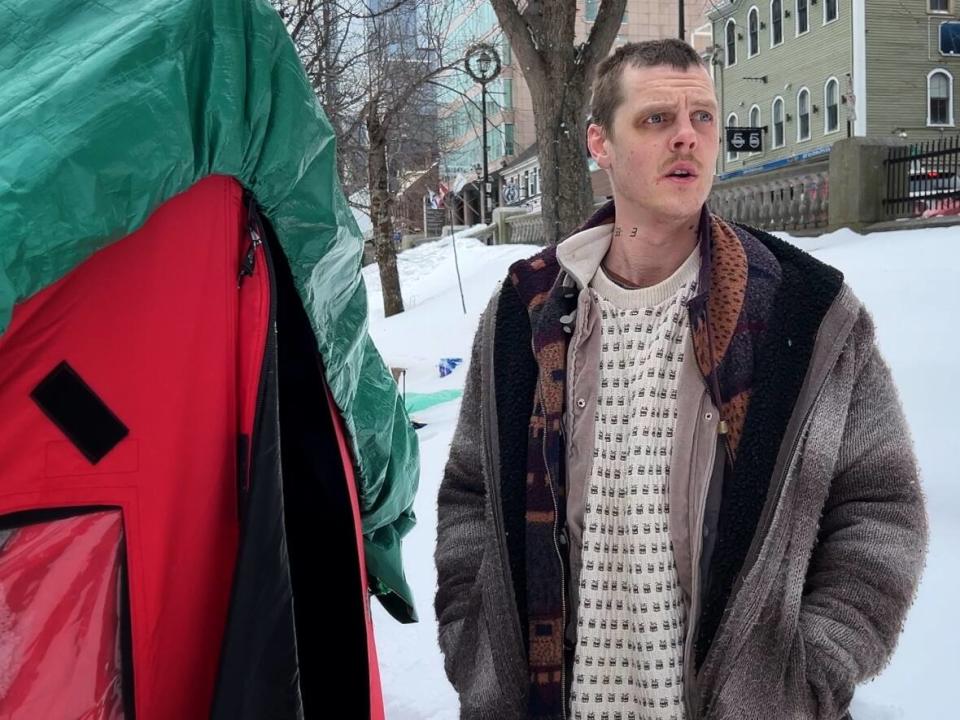 Nicholas Robert Coulombe speaks outside of his tent in Grand Parade in Halifax on Wednesday. (Brett Ruskin/CBC - image credit)