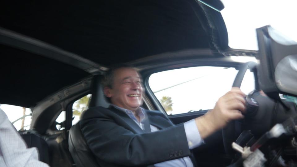 lucid's ceo peter rawlinson at the wheel of an air