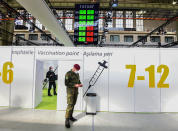 A soldier of the German Armed Forces Bundeswehr stands inside a new vaccination centre at the former Tempelhof airport in Berlin, Germany, before its opening on Monday, March 8, 2021. (Tobias Schwarz / Pool via AP)