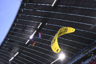 Paraglider soars through the air prior the start of the Euro 2020 soccer championship group F match between Germany and France at the Allianz Arena stadium in Munich, Tuesday, June 15, 2021. (Franck Fife/Pool via AP)