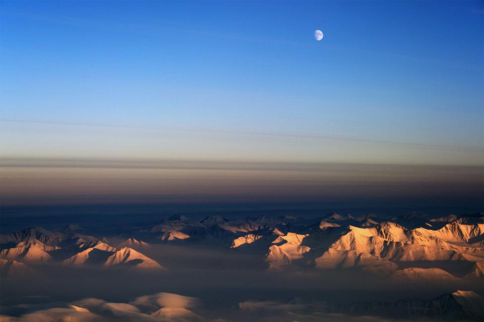 The moon is seen north of the Fram Strait in northeast Greenland in this NASA Operation IceBridge picture