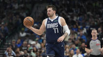 Dallas Mavericks guard Luka Doncic handles the ball during the first half of an NBA basketball game against the Denver Nuggets in Dallas, Sunday, March 17, 2024. (AP Photo/LM Otero)