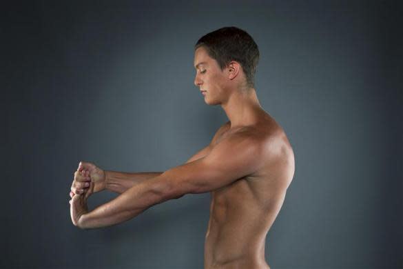 Diver Thomas Finchum stretches while posing for a portrait during the 2012 U.S. Olympic Team Media Summit in Dallas, May 15, 2012.