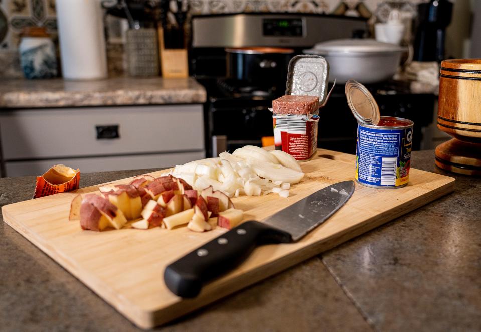 Ingredients for conbif, Puerto Rican corned beef hash, fill a cutting board in CK Ledesma's kitchen in Milwaukee on June 23, 2023. The dish was part of Ledesma's 2020 project Proyecto Conbif.