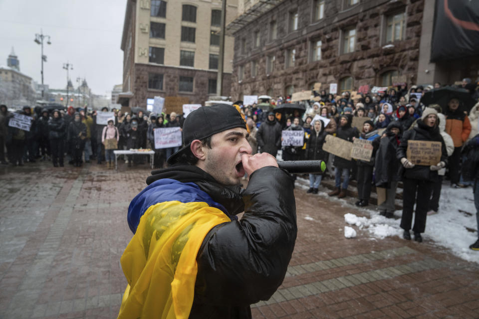 An activist shouts with a microphone during a protest in front of the city council of Kyiv, Ukraine, Thursday, Dec. 14, 2023. 500 representatives of the territorial community of Kyiv and the "Money for the Ukrainian Armed Forces" initiative group came to the protest to support the Security and Defense Forces of Ukraine from the budget of Kyiv, which is filled at the expense of taxpayers, subventions and other revenues. (AP Photo/Evgeniy Maloletka)