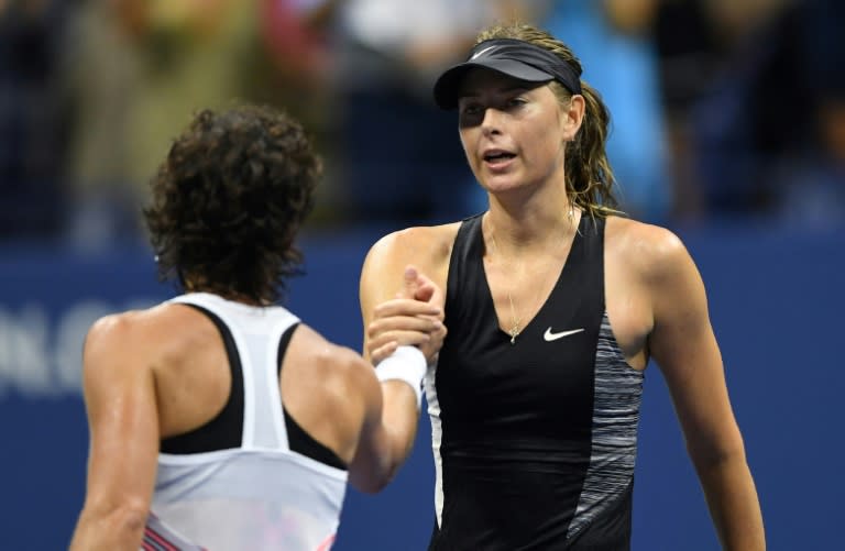 Too good: Carla Suarez Navarro shakes hands with Maria Sharapova