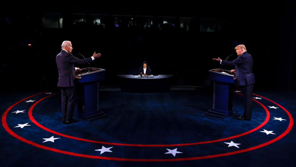 US President Donald Trump (R) Democratic Presidential candidate, former US Vice President Joe Biden and moderator, NBC News anchor, Kristen Welker (C) participate in the final presidential debate at Belmont University in Nashville, Tennessee, on October 22, 2020.  (Jim Bourg / AFP via Getty Images)