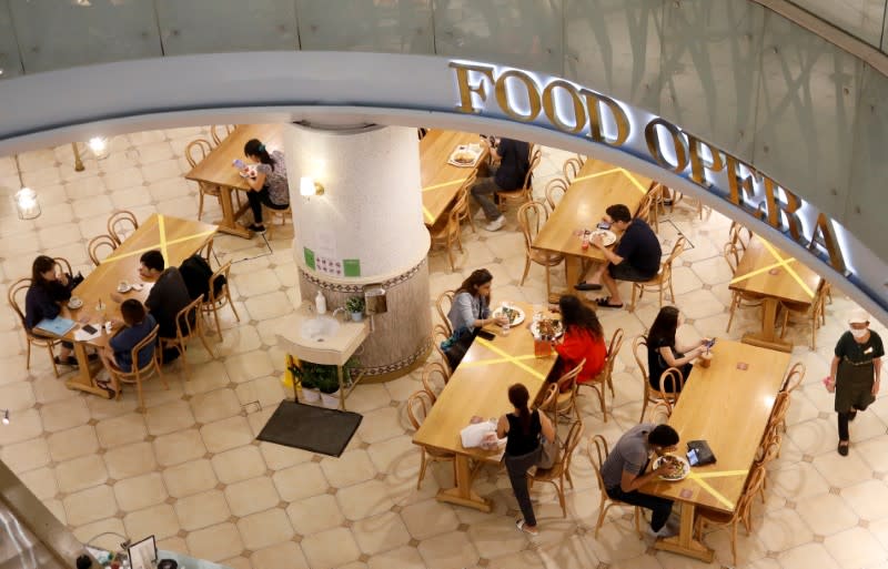 Tables and chairs are taped up to encourage social distancing, due to the outbreak of the coronavirus disease (COVID-19), at a food court in Singapore