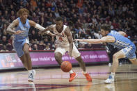 Virginia Tech guard Nahiem Alleyne (4) drives between North Carolina defenders Armando Bacon (5) and Andrew Platek (3) during the second half of an NCAA college basketball game in Blacksburg, Va., Wednesday, Jan. 22, 2020.(AP Photo/Lee Luther Jr.)