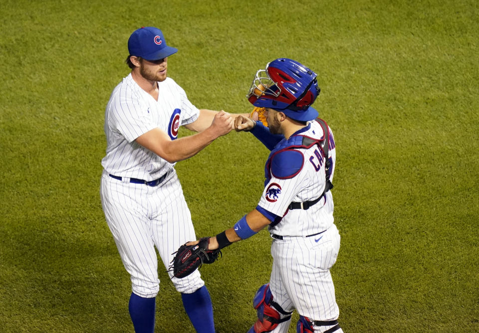 CHICAGO, ILLINOIS - AUGUST 13: Rowan Wick #50 of the Chicago Cubs and Victor Caratini #7 of the Chicago Cubs celebrate their team's 4-2 over the Milwaukee Brewers at Wrigley Field on August 13, 2020 in Chicago, Illinois. (Photo by Nuccio DiNuzzo/Getty Images)