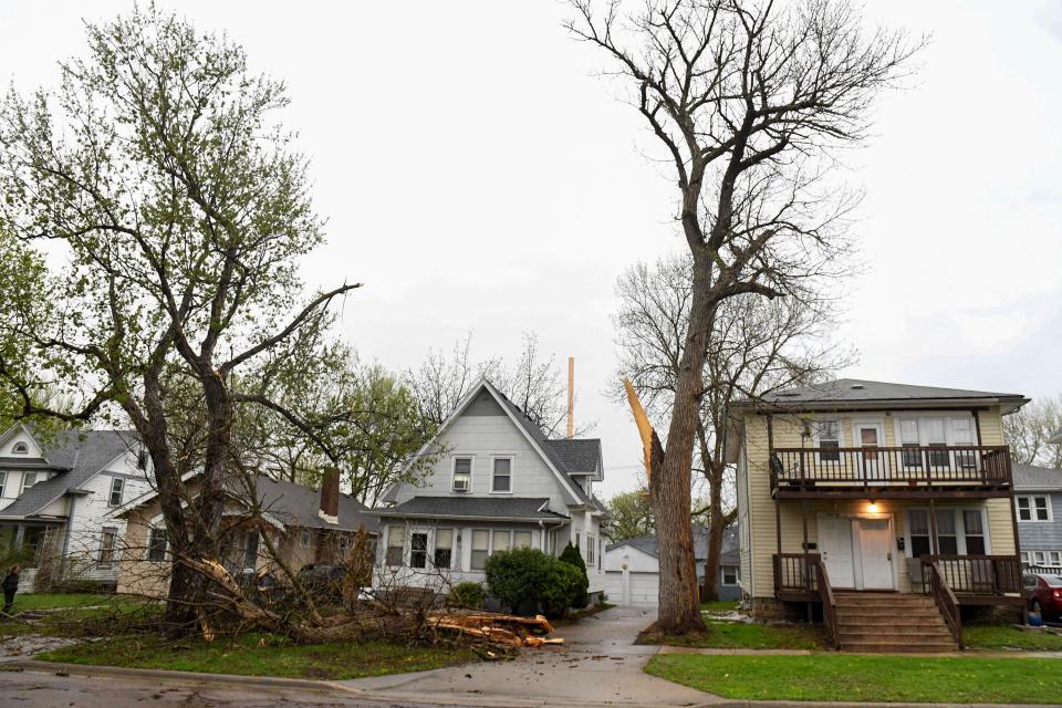 Storm damage is seen where a power line hit both a car and a tree at 16th Street and Spring Avenue on Thursday, May 12, 2022, in Sioux Falls.