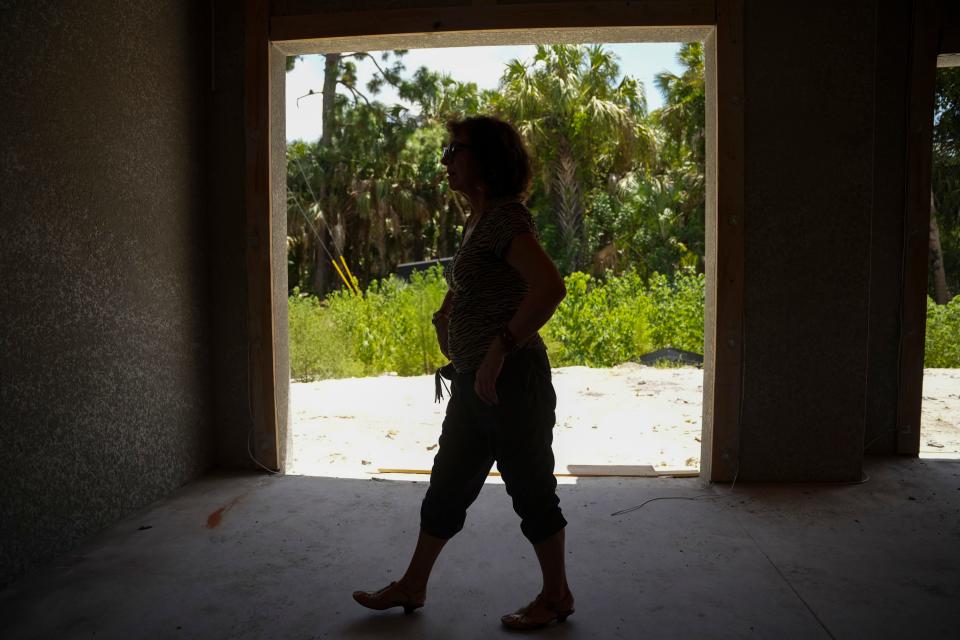 Lucy Deriy walks through the Metro Home Builders construction site in Naples on Tuesday, Aug. 15, 2023. It was going to be a home for the rest of their family that still live in Chicago.