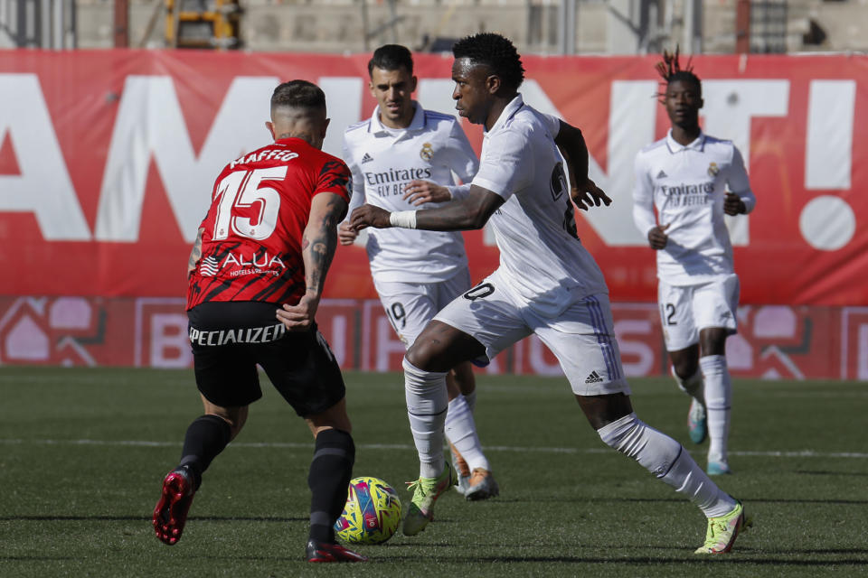 Real Madrid's Vinicius Junior in action against Mallorca's Pablo Maffeo during a Spanish La Liga soccer match between Mallorca and Real Madrid at the Son Moix stadium in Palma de Mallorca, Spain, Sunday, Feb. 5, 2023. (AP Photo/Francisco Ubilla)