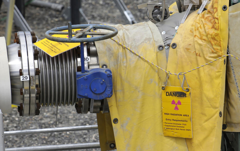 In this July 9, 2014 file photo, a sign warns of high levels of radiation near a valve at the "C" tank farm during a media tour of the Hanford Nuclear Reservation near Richland, Wash. Conservation groups are alarmed by the Trump administration's proposal to rename some radioactive waste left from the production of nuclear weapons to make it cheaper and easier to achieve permanent disposal. The U.S. Department of Energy is considering a change in its legal definition of high-level radioactive waste, which is stored at places like the Hanford. (AP Photo/Ted S. Warren, File)