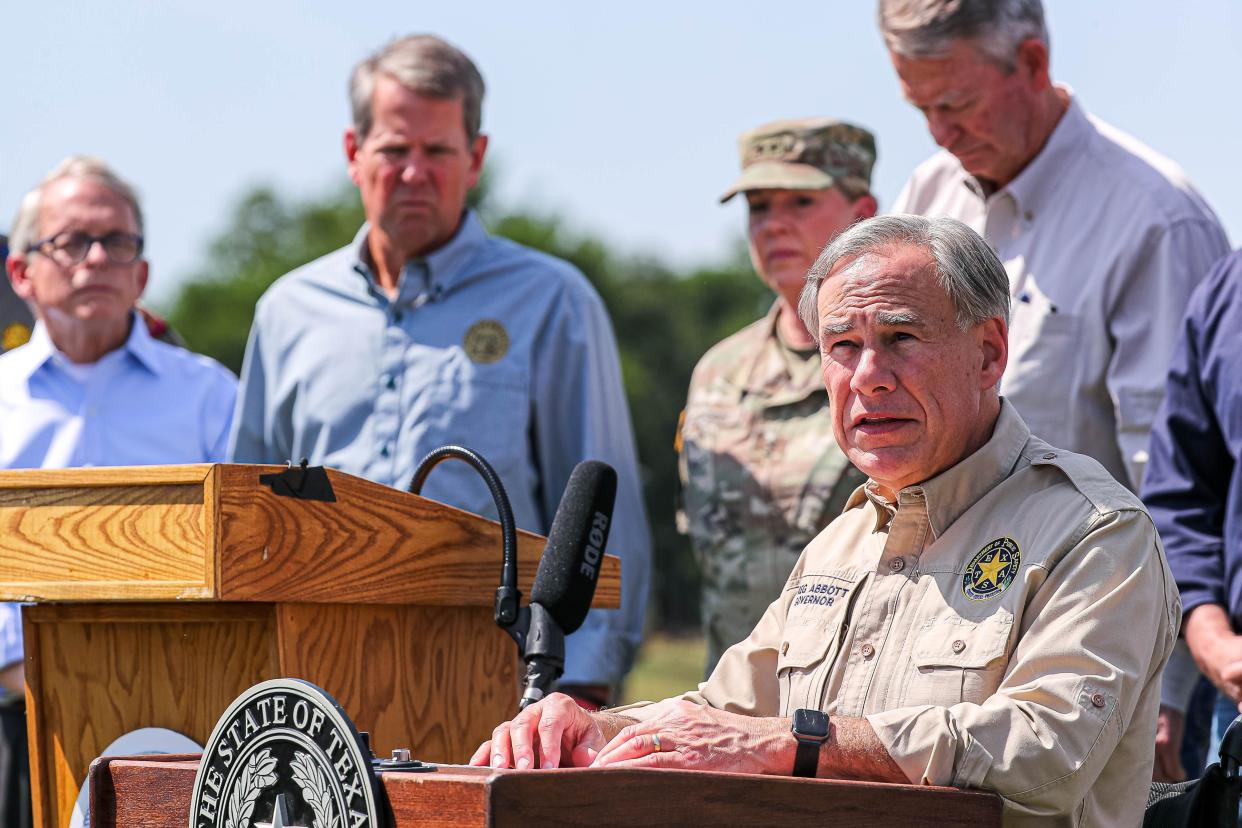 Gov. Greg Abbott, backed by other Republican state governors, Texas National Guard leaders and law enforcement officers, speaks at a press conference in October in Mission, near the Texas-Mexico border, to criticize the Biden administration's handling of border enforcement.