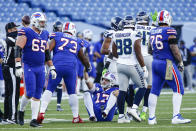Buffalo Bills quarterback Josh Allen (17) is helped up by a teammate after being sacked by Seattle Seahawks' Carlos Dunlap during the second half of an NFL football game Sunday, Nov. 8, 2020, in Orchard Park, N.Y. (AP Photo/John Munson)