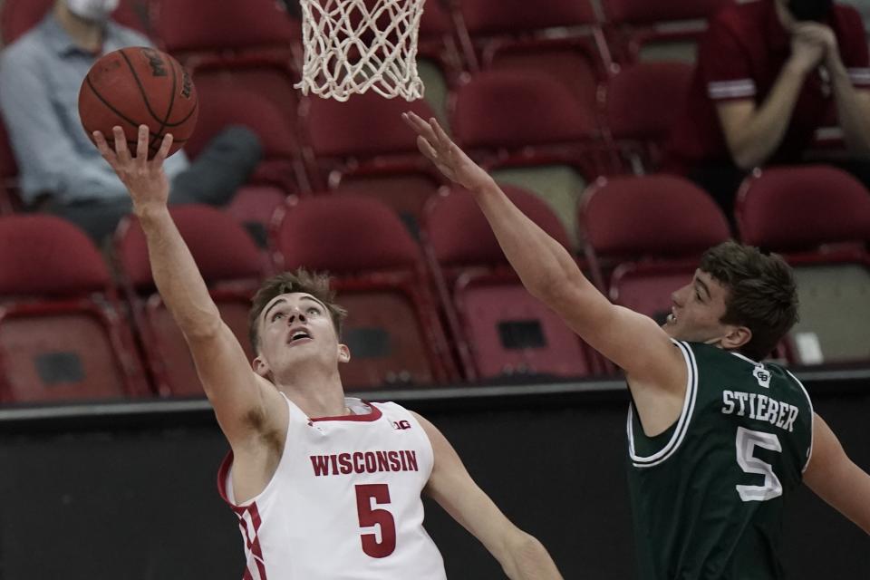 Wisconsin's Tyler Wahl shoots past Wisconsin-Green Bay's Lucas Stieber during the first half of an NCAA college basketball game Tuesday, Dec. 1, 2020, in Madison, Wis. (AP Photo/Morry Gash)