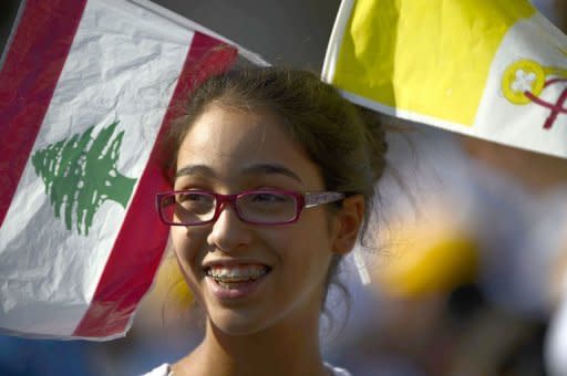 A girl smiles as she waits in the Lebanese mountain village of Bkerke, overlooking the capital Beirut, for the arrival of Pope Benedict XVI