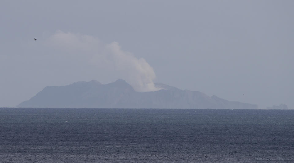 A plume of steam is seen above White Island early morning off the coast of Whakatane, New Zealand, Tuesday, Dec. 10, 2019.  A volcanic island in New Zealand erupted Monday Dec. 9 in a tower of ash and steam while dozens of tourists were exploring the moon-like surface, killing at least five people and leaving many more missing. (AP Photo/Mark Baker)