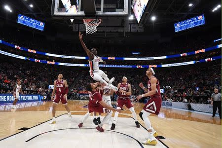 Mar 21, 2019; Salt Lake City, UT, USA; Auburn Tigers guard Jared Harper (1) goes up for a shot and collides with New Mexico State Aggies forward Johnny McCants (35) during the first half in the first round of the 2019 NCAA Tournament at Vivint Smart Home Arena. Mandatory Credit: Kirby Lee-USA TODAY Sports