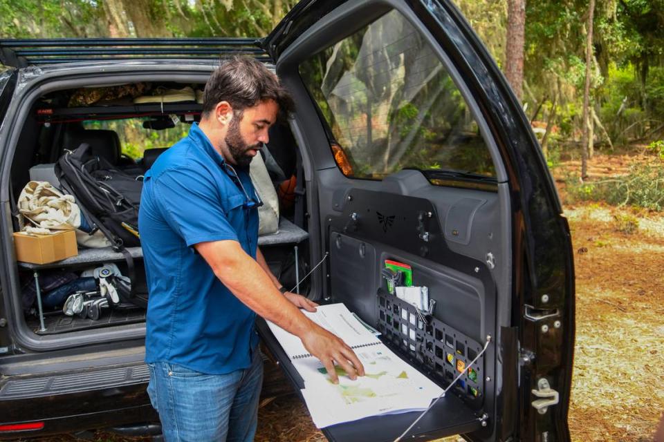 Working out of the back of his SUV, Elvio Tropeano shows the plan for his development of Pine Island Golf Club on May 23, 2023 while parked on the mainland bluff of Pine Island Plantation on St. Helena Island. Drew Martin/dmartin@islandpacket.com