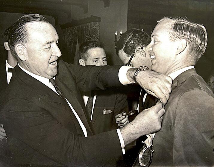 Los Angeles, California-During a campaign event in 1966, then-Gov. Pat Brown, left, pinned a ribbon on the jacket of Times journalist George Skelton, right. (Courtesy of George Skelton)