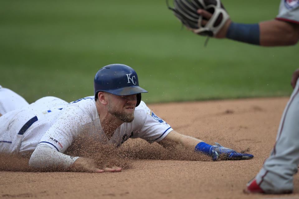 Kansas City Royals' Hunter Dozier slides into third base during the eighth inning of a baseball game against the Minnesota Twins at Kauffman Stadium in Kansas City, Mo., Sunday, Sept. 29, 2019. Dozier tripled on the play. (AP Photo/Orlin Wagner)