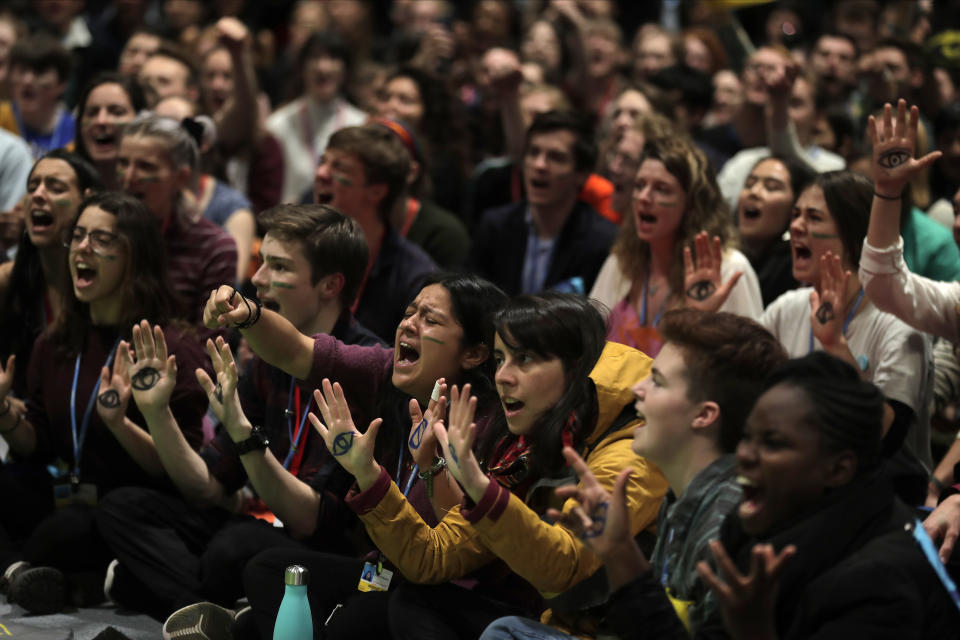 People shout slogans during a march organized by the Fridays for Future international movement of school students at the COP25 climate talks congress in Madrid, Spain, Friday, Dec. 13, 2019. The United Nations Secretary-General has warned that failure to tackle global warming could result in economic disaster. (AP Photo/Manu Fernandez)