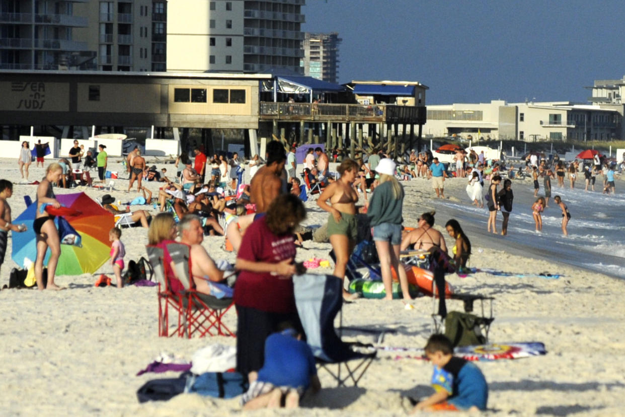 Beachgoers are shown on the coast at Gulf Shores, Ala., on Thursday, Aug. 12, 2021. Alabama's coastal counties lead the state in new COVID-19 cases, and some events have been canceled in Florida and Louisiana because of the latest surge. Health officials believe the spike is due to a combination of some of the nation’s lowest vaccination rates, unabated tourism, a disregard for basic health precautions and the region’s carefree lifestyle. (AP Photo/Jay Reeves)