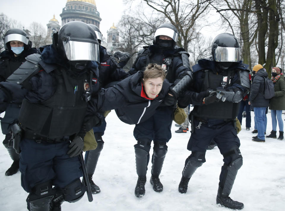 Police detain a man during a protest against the jailing of opposition leader Alexei Navalny in People gather in St.Petersburg, Russia, Saturday, Jan. 23, 2021. Russian police are arresting protesters demanding the release of top Russian opposition leader Alexei Navalny at demonstrations in the country's east and larger unsanctioned rallies are expected later Saturday in Moscow and other major cities. (AP Photo/Dmitri Lovetsky)