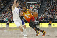 Utah Jazz guard Mike Conley (10) drives around Indiana Pacers guard T.J. McConnell (9) in the second half of an NBA basketball game Monday, Jan. 20, 2020, in Salt Lake City. (AP Photo/Rick Bowmer)