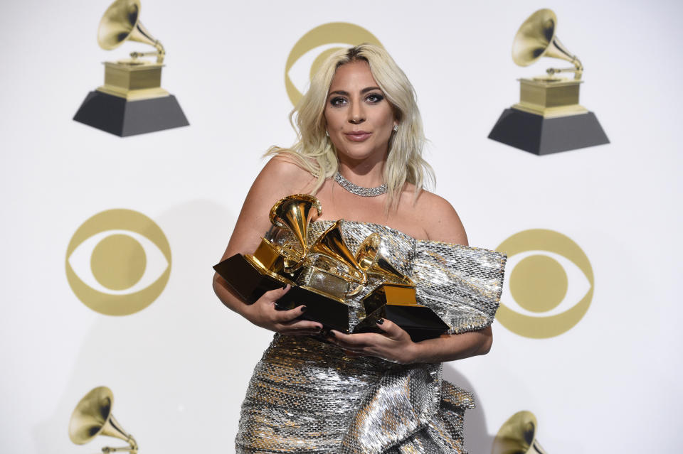 Lady Gaga poses in the press room with her awards for best pop solo performance for 