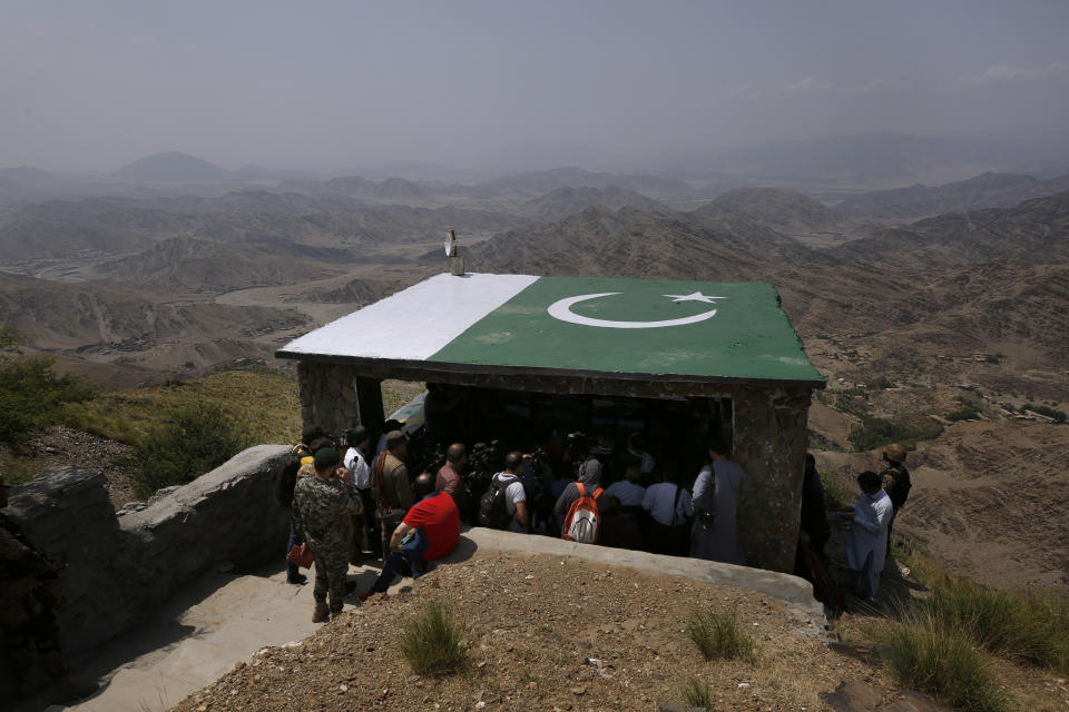 Members of International media attend a briefing during their visit to a hilltop post on the Pakistan Afghanistan border in Khyber district, Pakistan, Tuesday, Aug. 3, 2021. Pakistan's military said it completed 90 percent of the fencing along the border with Afghanistan, vowing the remaining one of the most difficult tasks of improving the border management will be completed this summer to prevent any cross-border militant attack from both sides. (AP Photo/Anjum Naveed)