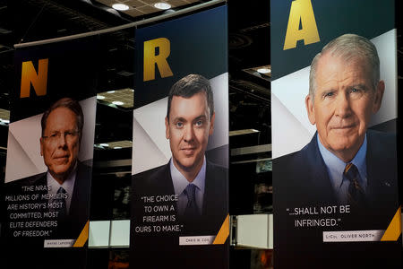 Images of NRA CEO Wayne LaPierre, Legislative Director Chris Cox and President Oliver North displayed during the National Rifle Association (NRA) annual meeting at the Indiana Convention center in Indianapolis, Indiana, U.S., April 27, 2019. REUTERS/Bryan Woolston