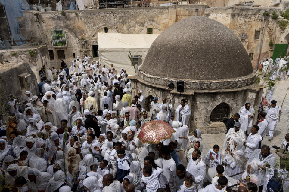 Ethiopian Orthodox Christian worshippers gather for Palm Sunday celebrations at the Ethiopian monks' quarters on the rooftop of the Church of the Holy Sepulcher, the place where Christians believe Jesus Christ was crucified, buried and resurrected, in Jerusalem, Sunday, April 9, 2023. (AP Photo/Ohad Zwigenberg)