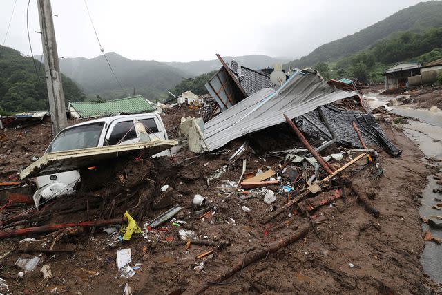 <p>YONHAP/AFP via Getty </p> A damaged house amid ongoing heavy rains in South Korea.