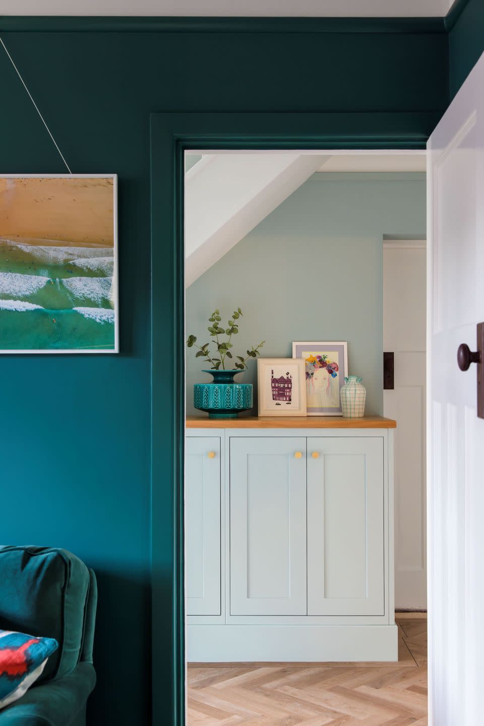 a white cabinet with a plant on top