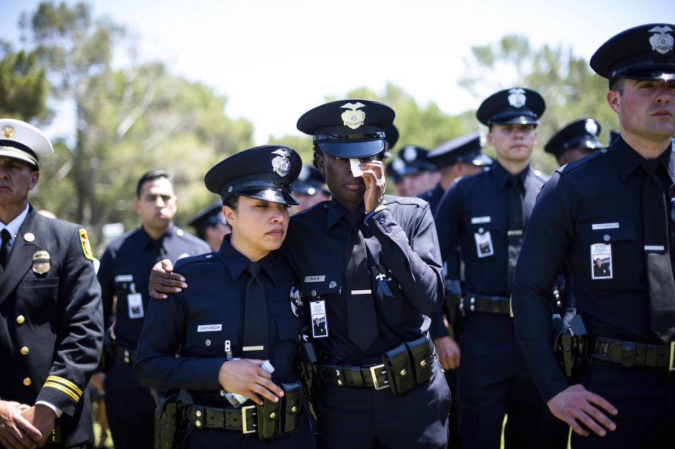 Los Angeles Police Department officers mourn during the funeral of fellow Officer Juan Jose Diaz at Forest Lawn Hollywood Hills cemetery, Monday, Aug. 12, 2019, in Los Angeles. Diaz was killed while off duty in Lincoln Heights after visiting a taco stand. (Sarah Reingewirtz/The Orange County Register via AP)