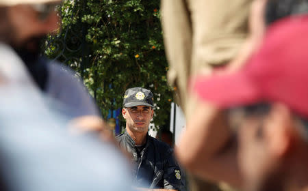 A police officer stands outside the parliament during a demonstration against a bill that would protect those accused of corruption from prosecution in Tunis, Tunisia September 13, 2017. REUTERS/Zoubeir Souissi