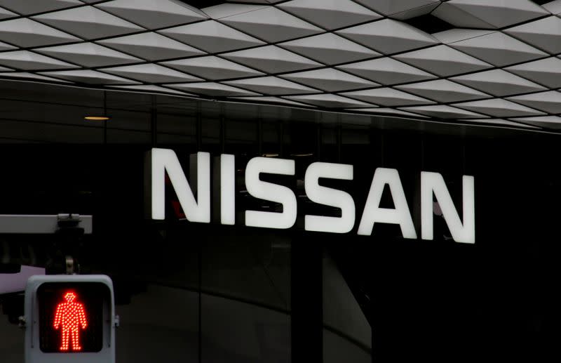 FILE PHOTO: The logo of Nissan Motor Co. is seen at its show room behind a traffic sign in Tokyo