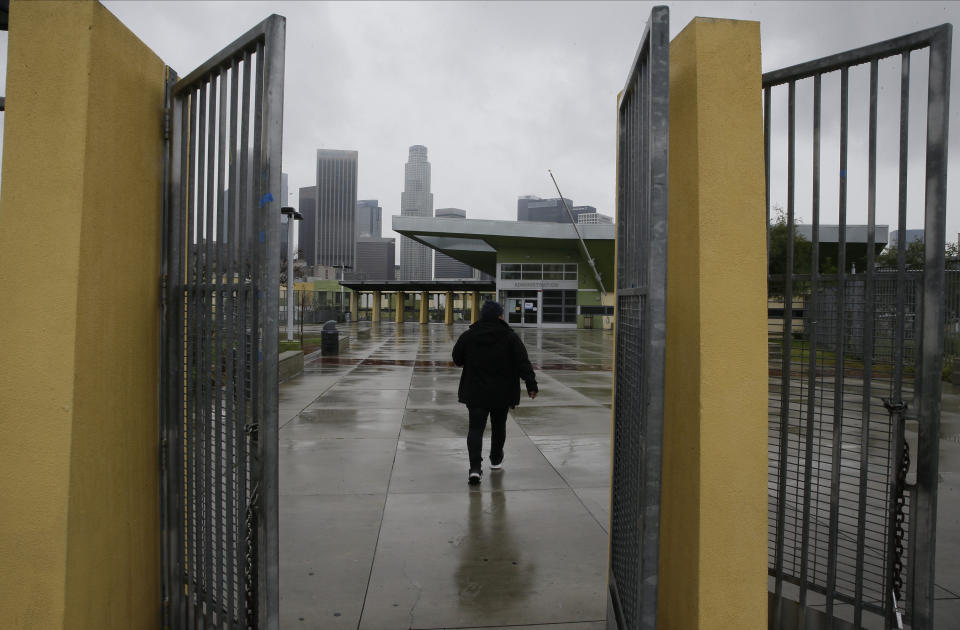 FILE - In this March 13, 2020, file photo, a parent arrives at the Edward R. Roybal Learning Center in Los Angeles, to pick up a student after the Los Angeles Unified School District announced the closure of the Los Angeles district schools for two weeks. An effort to reopen schools in California is foundering, stoking the frustration of parents and the governor of America's biggest and wealthiest state. As the one-year anniversary of distance learning approaches, parents are grappling more than ever with the toll of isolation and intense screen time on their kids well-being. (AP Photo/Damian Dovarganes, File)