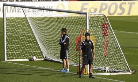 German national soccer coach Joachim Loew and assistant coach Thomas Schneider (L) conduct a team training session in Essen October 13, 2014. REUTERS/Wolfgang Rattay/Files